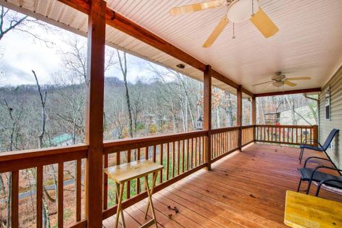 a screened in porch with a ceiling fan and chairs at Trimont Mountain Cottage in Franklin