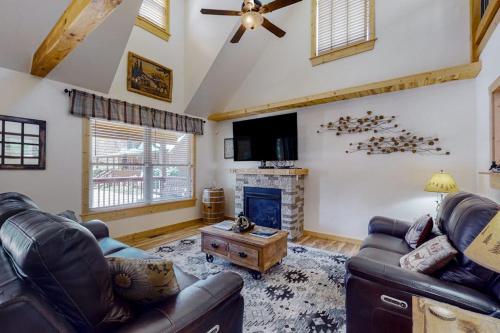 a living room with leather furniture and a fireplace at The Mountain Haven in Maggie Valley
