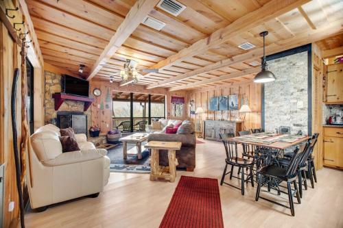 a kitchen and living room with a table and chairs at Black Bear Cabin Fox Mountain in Franklin