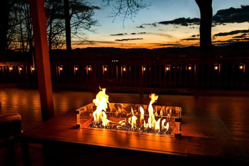 a fire pit in the middle of the water at sunset at Black Bear Cabin Fox Mountain in Franklin