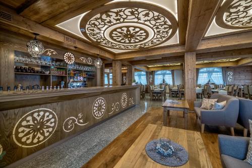 a bar in a restaurant with wooden ceilings at Hotel Górski in Białka Tatrzanska