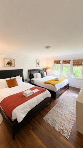 a bedroom with two beds and a rug at Evergreen House in Vancouver
