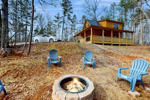 a fire pit with four chairs and a house at Whispering Pines in Murphy