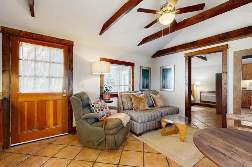 a living room with a couch and a table at Main Street Wood Cottage in Brevard