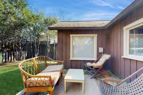 a patio with chairs and a couch and a table at Main Street Wood Cottage in Brevard