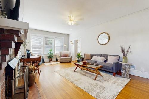 a living room with a couch and a fireplace at Main Street Brick Cottage in Brevard