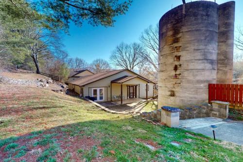 a house with a large silo in the yard at Hominy Creek Haven in Candler