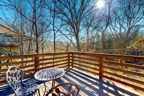 a wooden deck with a table and chairs on a fence at Hominy Creek Haven in Candler