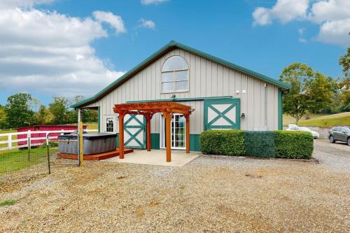 a large white barn with a gazebo in front at Gibbs Getaway in Leicester