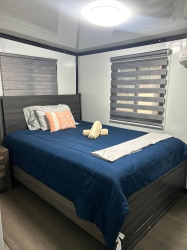 a bed with two pillows on it in a room at Babus Villas del Sol in El Combate