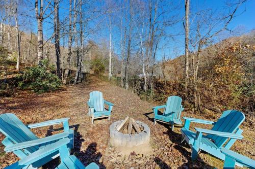 a group of blue chairs around a fire pit at Pebble on The Creek in Whittier