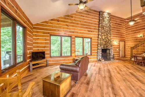 a living room with a couch and a fireplace at Close to Heaven in Sylva