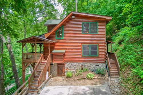 a log cabin in the woods with a staircase at Forest Hideaway in Maggie Valley