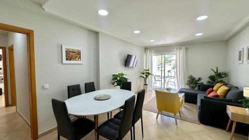 a living room with a table and chairs and a couch at Liberdade - Near the beach - 6 Pax - Albufeira in Albufeira