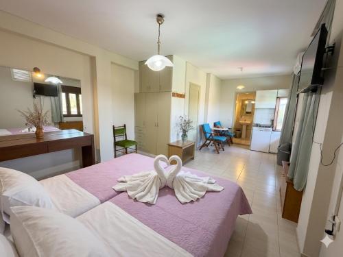 a room with a bed with a towel on it at Ta Kalamakia Apartments in Vatera
