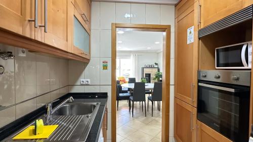 a kitchen with a sink and a dining room at Liberdade - Near the beach - 6 Pax - Albufeira in Albufeira