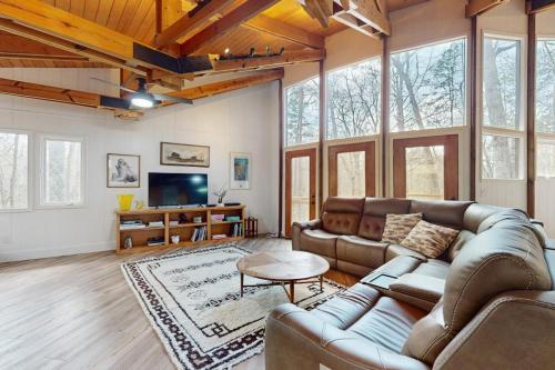 a living room with a couch and a table at Red Fox Lair in Franklin