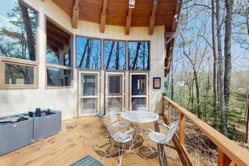 a house with a table and chairs on a deck at Red Fox Lair in Franklin