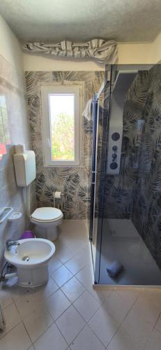 a bathroom with a toilet and a shower at Residence Villa delle Rose in Lampedusa