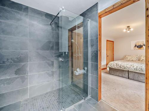 a bathroom with a shower and a bedroom with a bed at 4 Bed in Forton oc-81290 in Forton