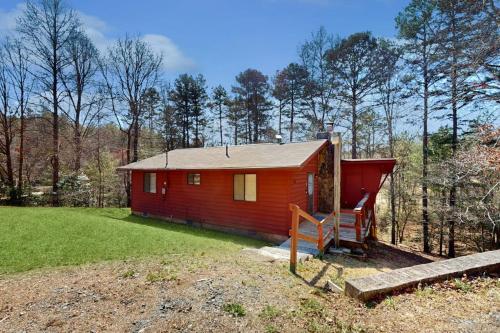 a small red cabin in the middle of a field at The Crocket Fortune in Murphy