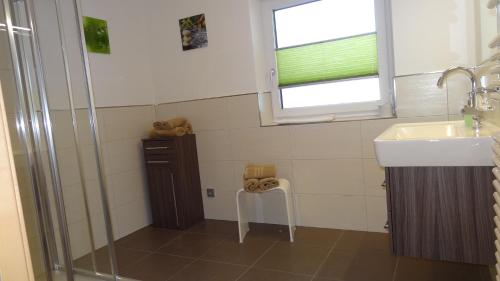 a bathroom with a sink and a shower at Appartements Gassner in Bruck an der Großglocknerstraße