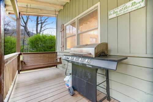 a grill on the porch of a house at Along the River Cottage in Cullowhee