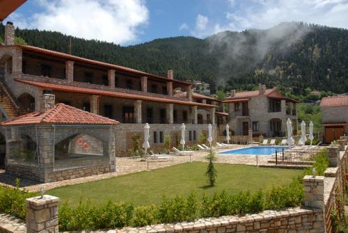 a large building with a yard with a swimming pool at Omalia Village in Áno Khóra