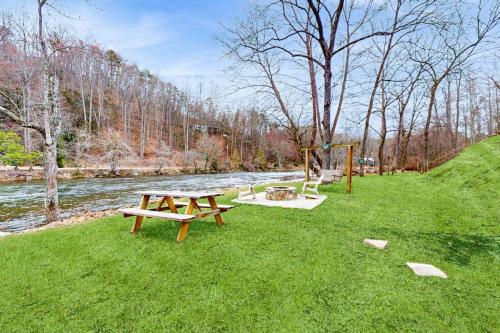 a park with a picnic table and a swing at Tuckaway Retreat in Sylva