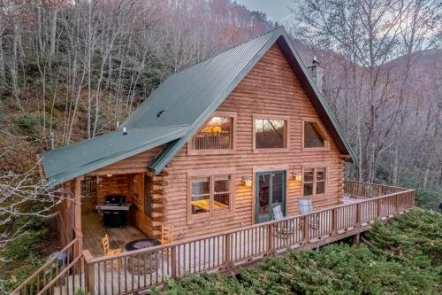 a log cabin with a gambrel roof at Cloud Walk in Sylva