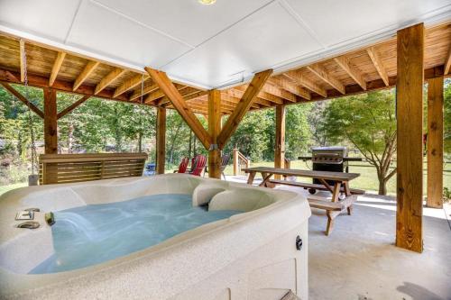 a large hot tub in a patio with a picnic table at Full Stream Ahead in Whittier