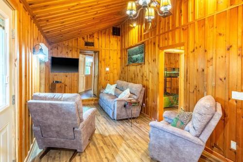 a living room with two chairs and a television at The Outpost in Whittier