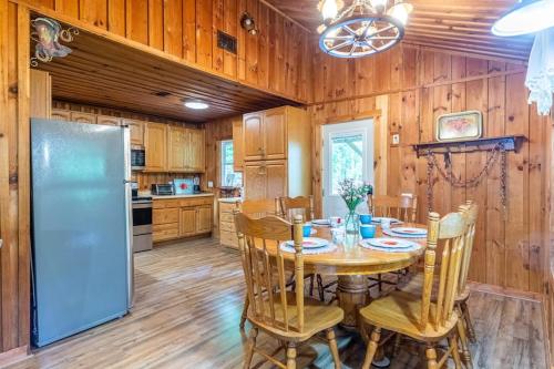 a dining room with a table and a refrigerator at The Outpost in Whittier