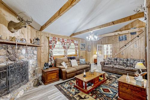 a living room with a couch and a fireplace at The Little Dude Cabin in Franklin