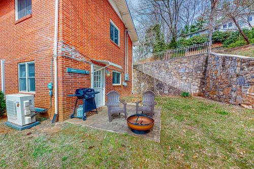a house with two chairs and a basketball hoop in the yard at Cozy Mountain Hideaway in Waynesville