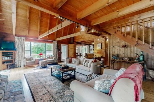 a living room with couches and a table at Walela Cabin in Topton