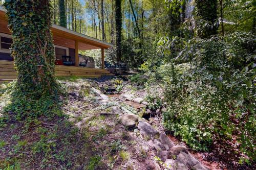 a cabin in the woods next to a tree at Bradley Bear Hideaway in Maggie Valley