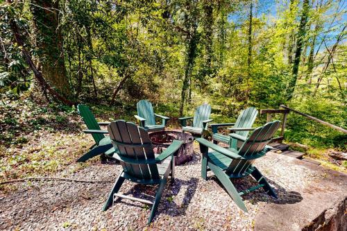 a group of chairs sitting around a fire pit at Bradley Bear Hideaway in Maggie Valley