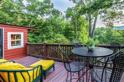 a patio with a table and chairs on a deck at The Treehouse in Franklin