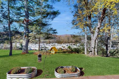two large flower pots in a park with trees at Shelba's Place in Sylva