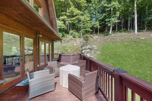 a porch with a table and chairs on a house at Peak and Pond Retreat in Scaly Mountain