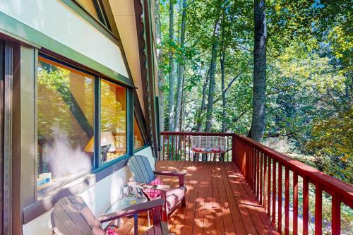 a balcony of a house with a view of trees at Chalet at Peek's Creek in Franklin