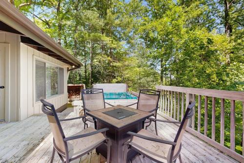 a patio with a table and chairs on a deck at Vista Heights Retreat in Bryson City