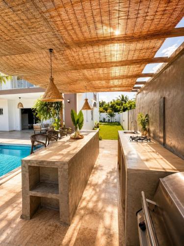 a patio with a table and a swimming pool at Villa costa mar in Cabrera