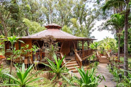 a gazebo in a garden with stairs and trees at Hawaiian Dream Temple in Kaupakulua