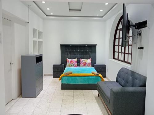 a bedroom with a bed and a couch at London 248 in Mexico City