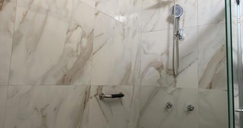 a bathroom with a shower with a glass door at reforma tecoman colima mexico in Tecomán