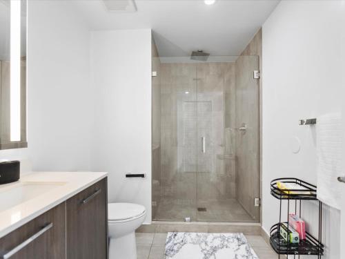 a bathroom with a shower and a toilet at 29th Floor Balcony Studio Miami Skyline Views in Miami