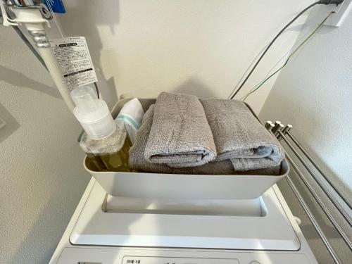 a white container with towels in a refrigerator at イーエフ千歳駅 in Chitose