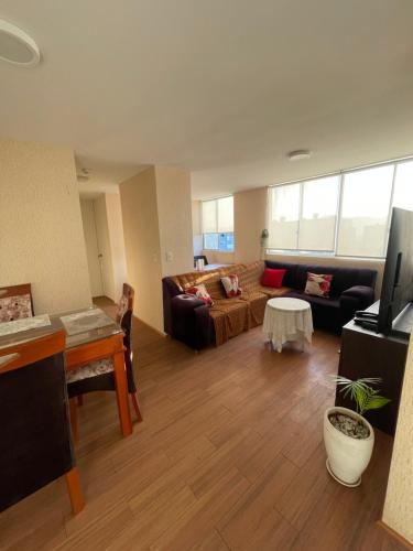 a living room with a couch and a table at Los Laureles -Executive Residence Departamento in Lima